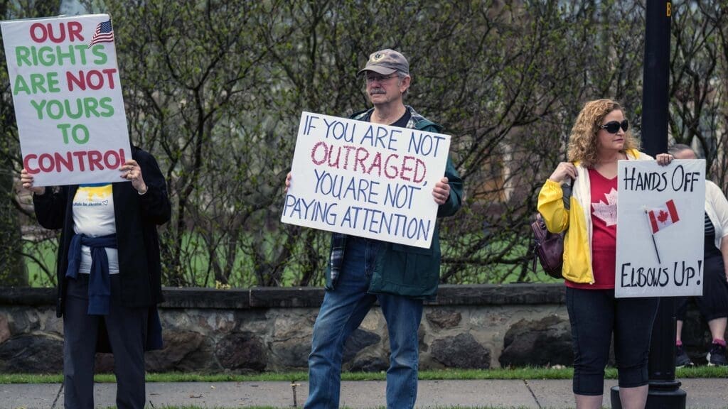 Protesters holding signs for rights and awareness.