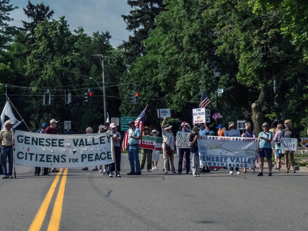 People protesting with peace banners on street.