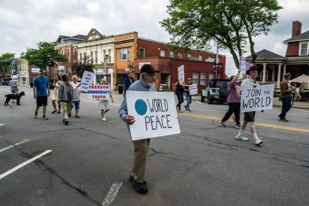 People marching for world peace in a town.