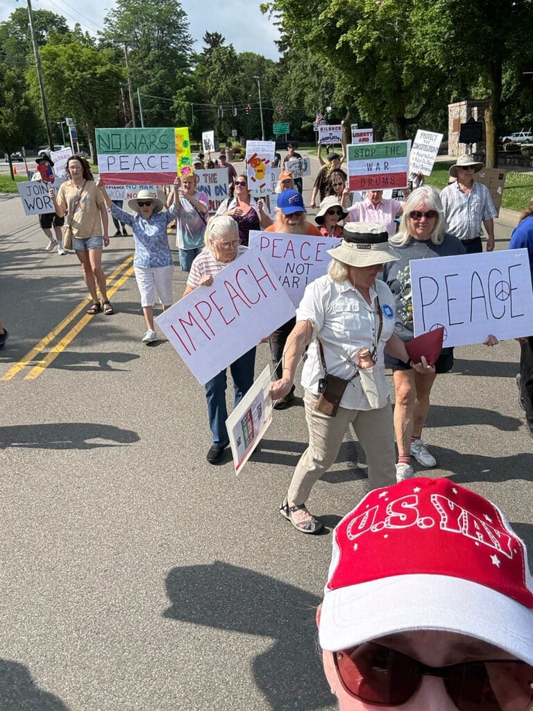 People marching with peace signs in protest.