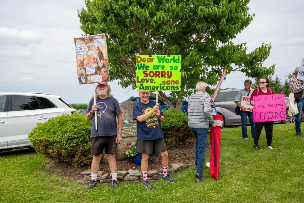 Protesters holding signs at a public demonstration.
