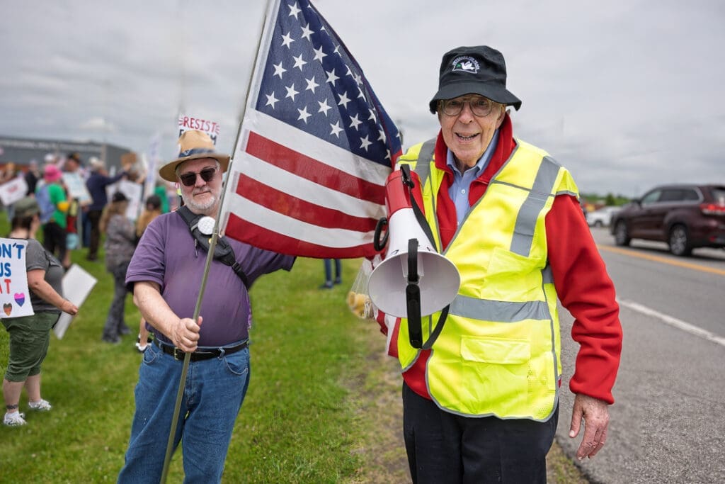 Protesters with American flag and megaphone.