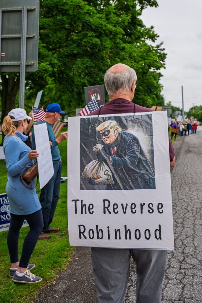 Protester holding anti-figure sign at demonstration