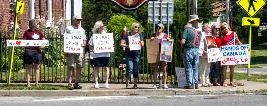 Group holding signs supporting Canada.