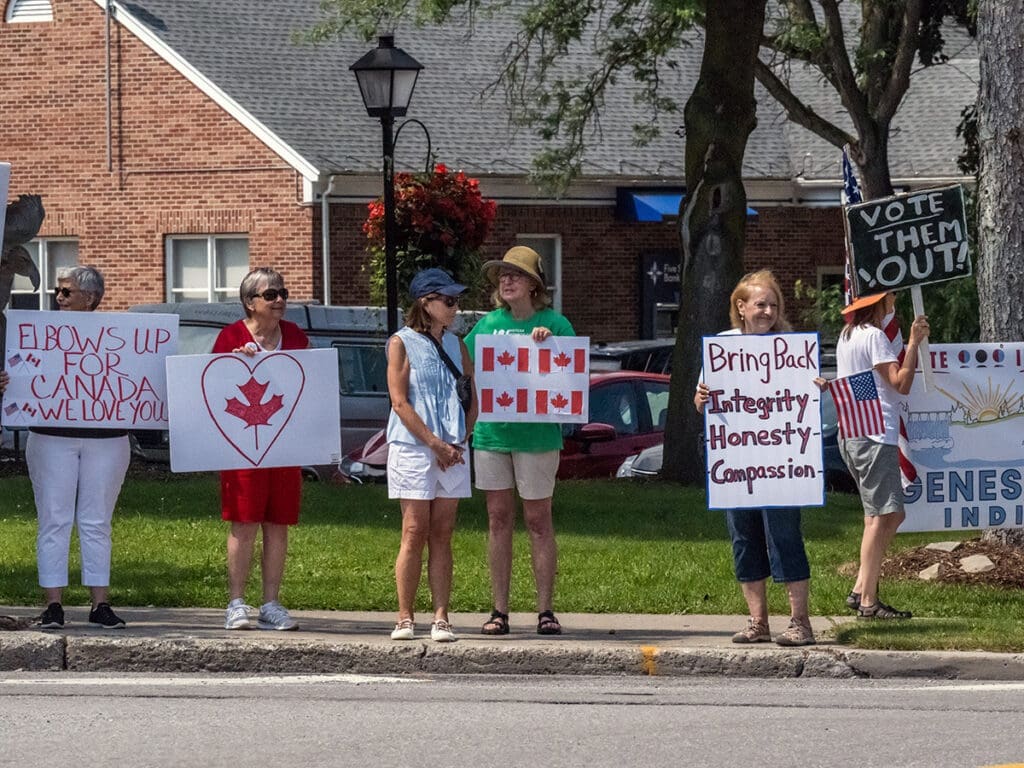 Protesters holding signs advocating for Canada and integrity.