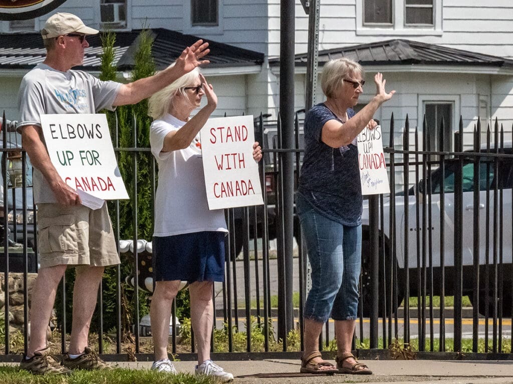 People with signs showing support for Canada.