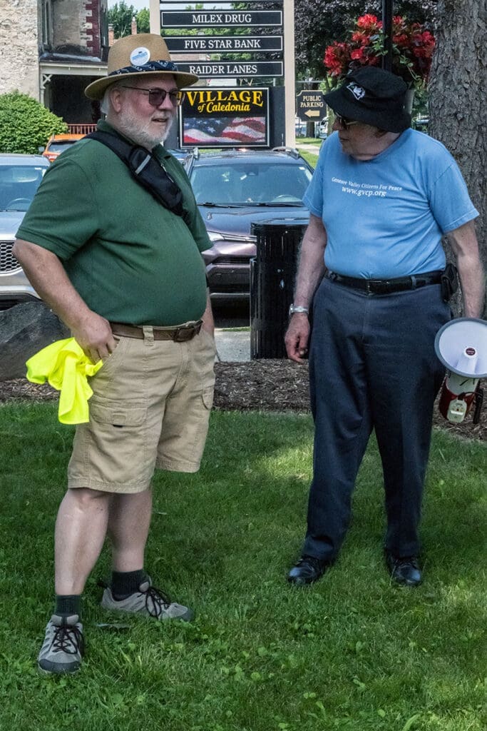 Two men talking outdoors in casual settings.