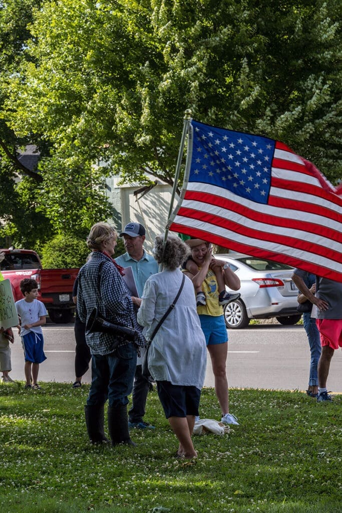 People gathered with American flag outdoors