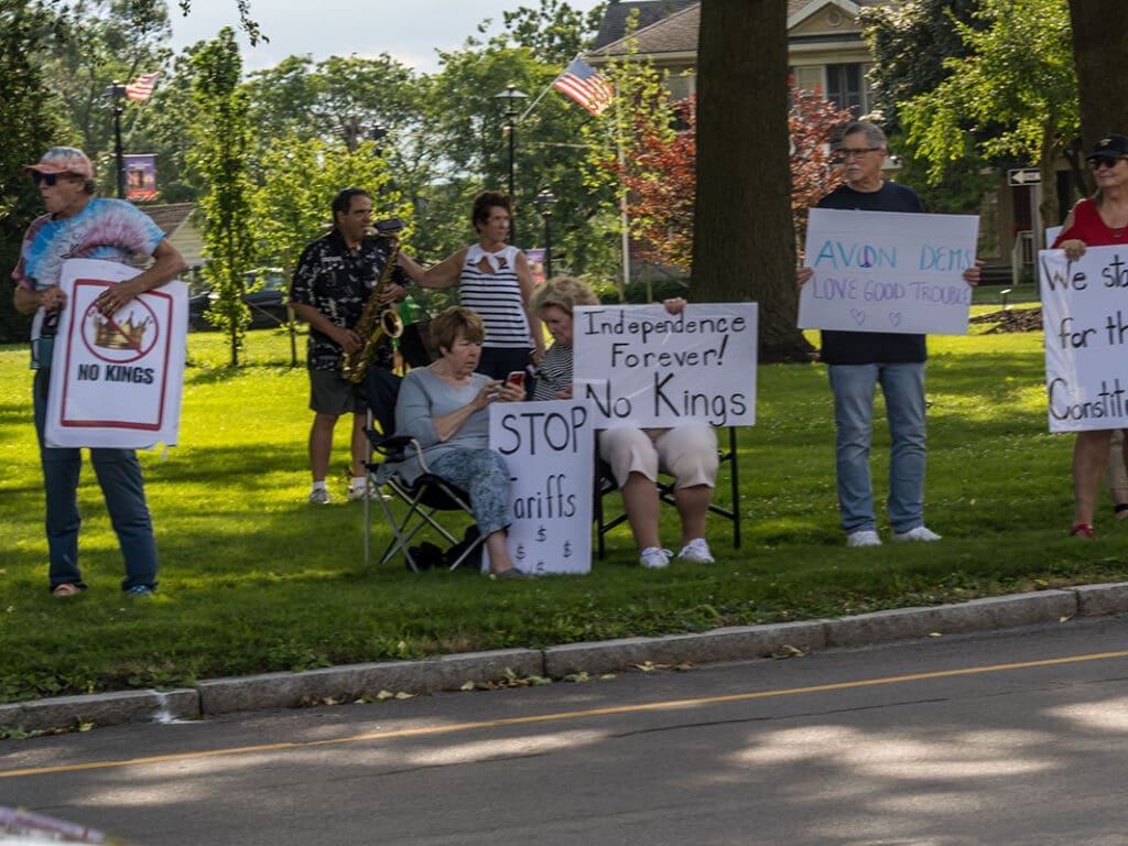 People at protest with signs in park