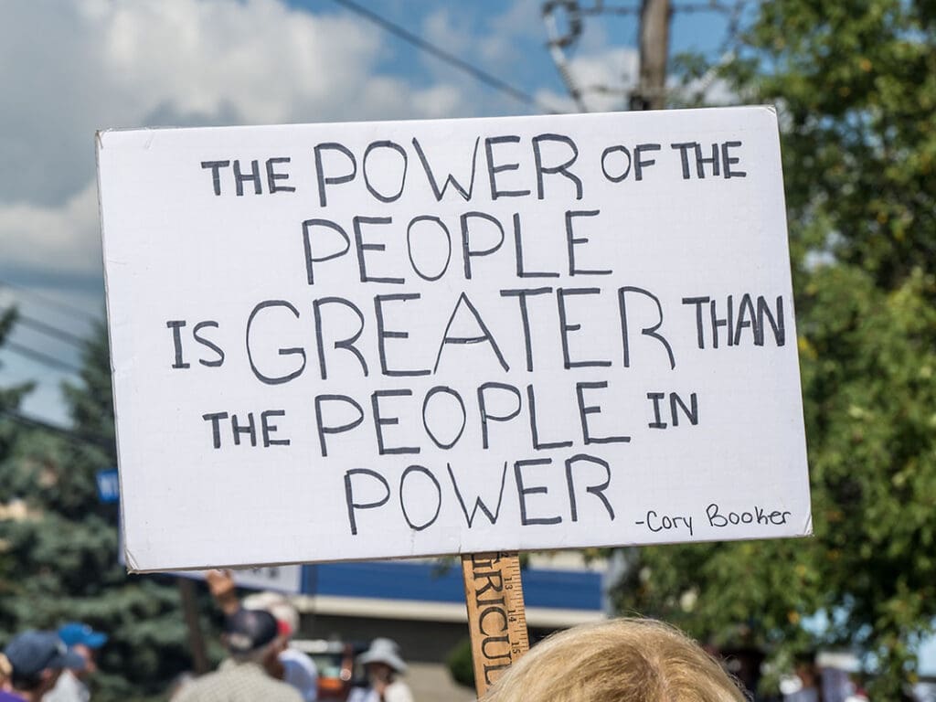 Protest sign: people power surpasses leadership authority.