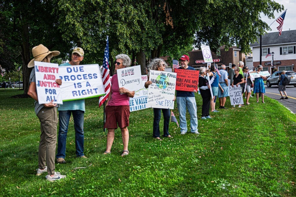 Protesters holding signs advocating for justice and democracy.