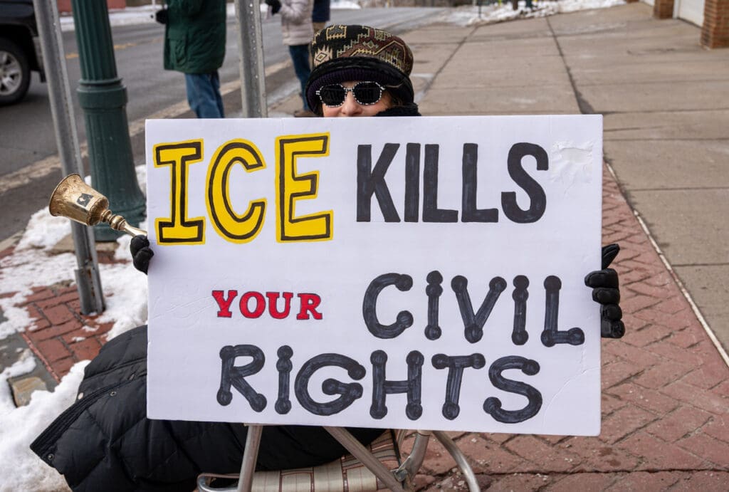 Protester holds sign about ICE and civil rights.