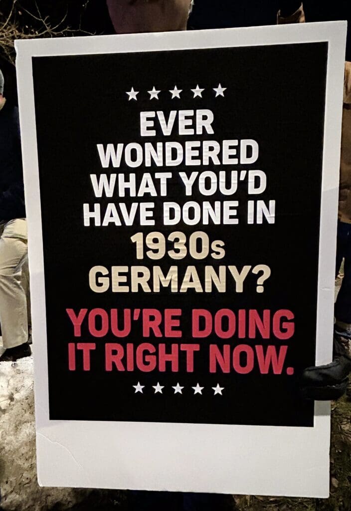 Protest sign about 1930s Germany comparison.