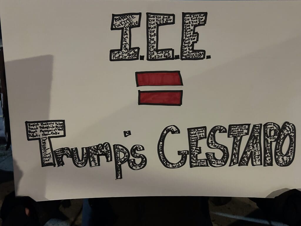 Protest sign comparing ICE to Gestapo.