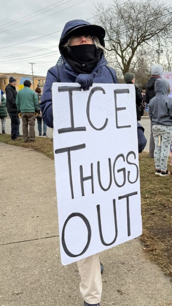 Protester holds sign: ICE Thugs Out.