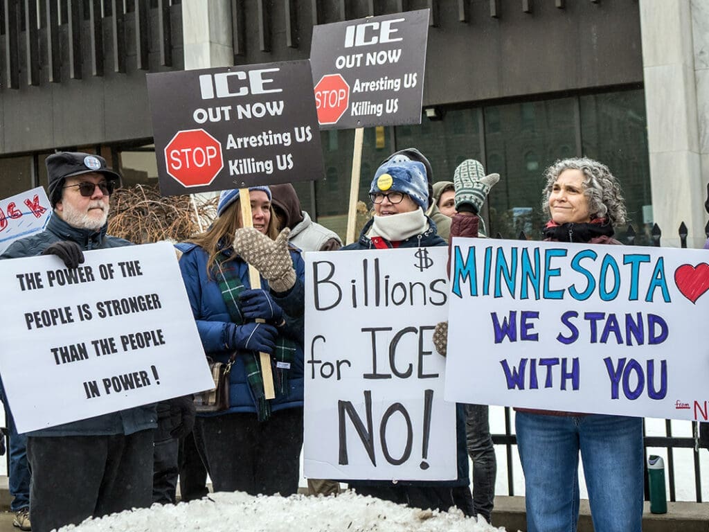Protesters with signs against ICE in Minnesota