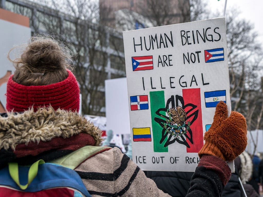 Protester holding sign about immigration rights.