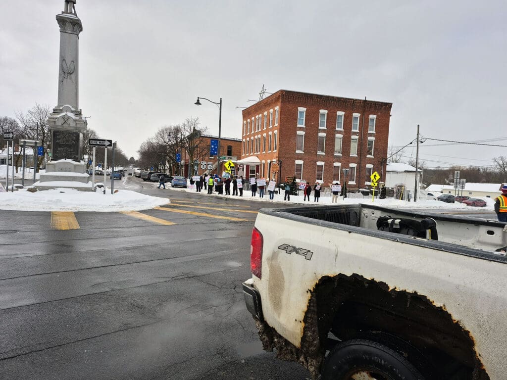 Street scene with snow and brick building.