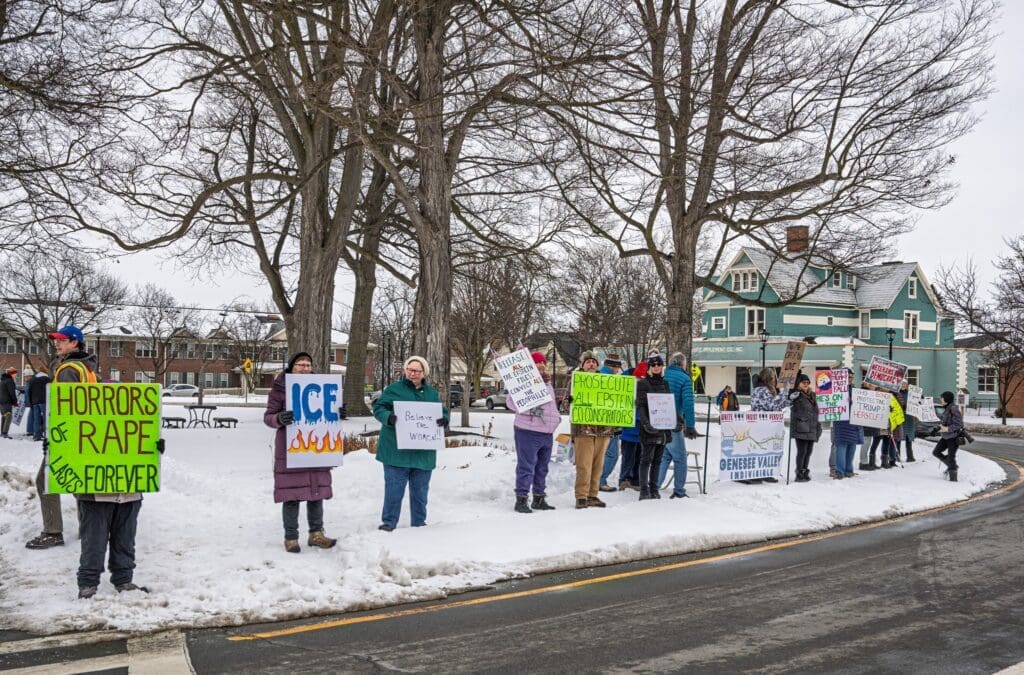 Protesters holding signs on snowy road.