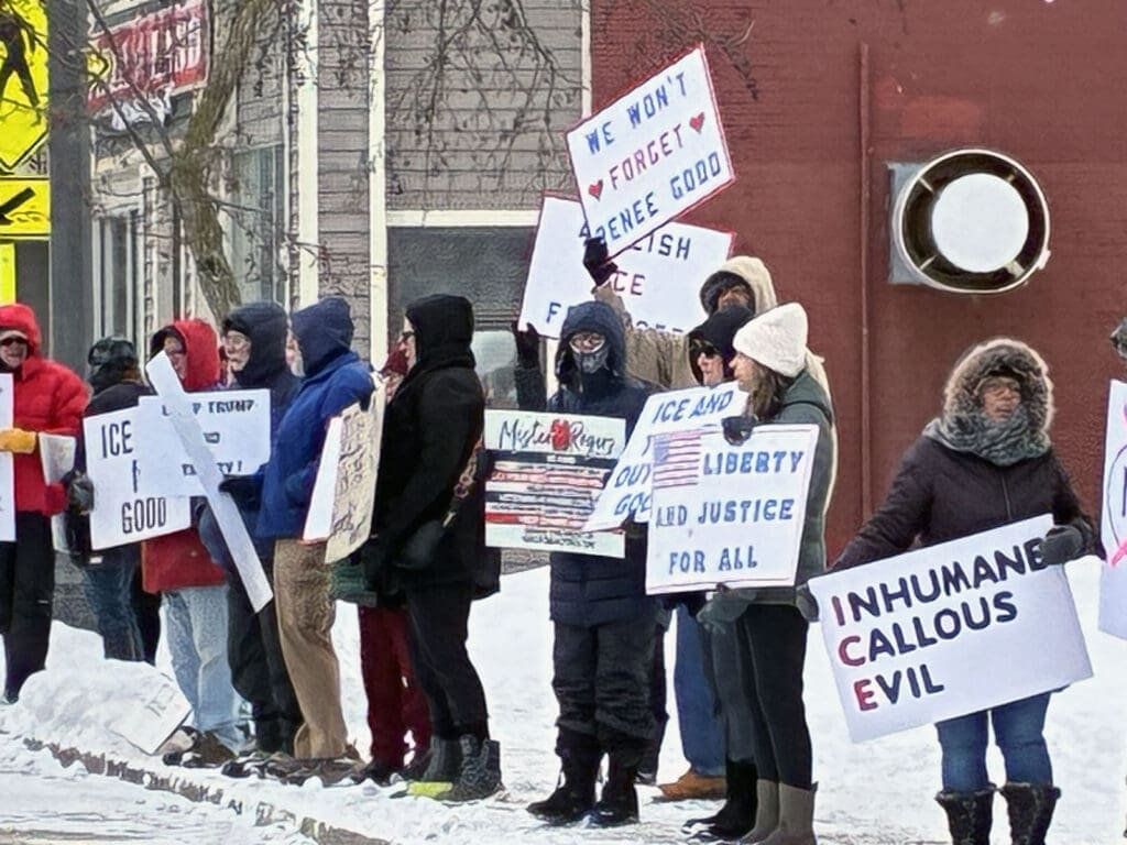 People protesting with signs in the snow