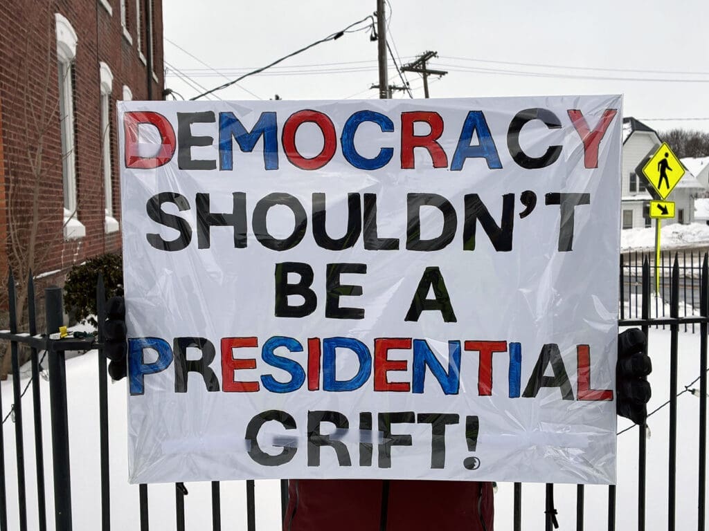Sign protesting presidential exploitation in democracy.