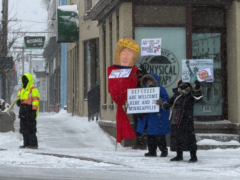 Protest in snowy Minneapolis welcoming refugees.