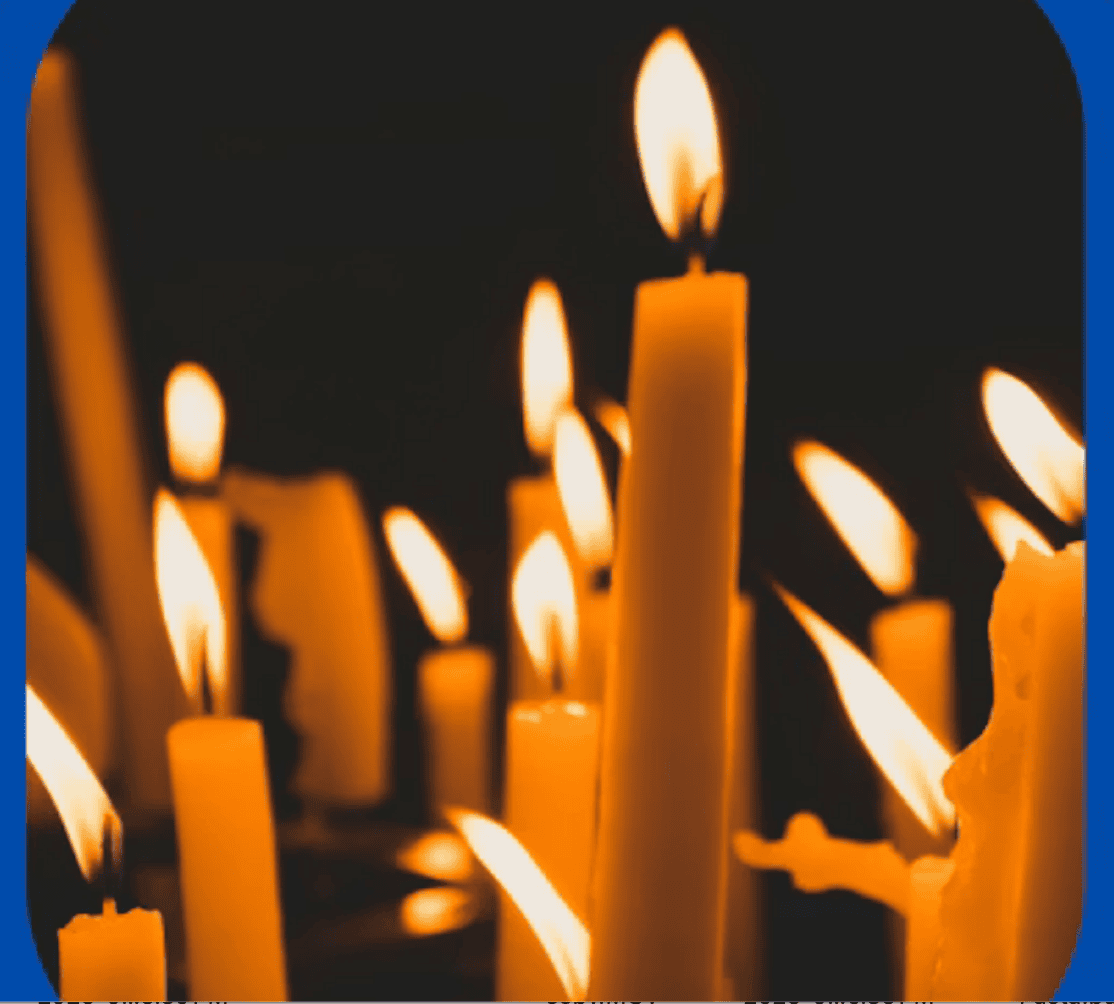 Close-up of lit candles in the dark.