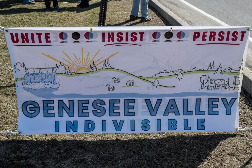 Genesee Valley Indivisible protest banner with landscape illustration