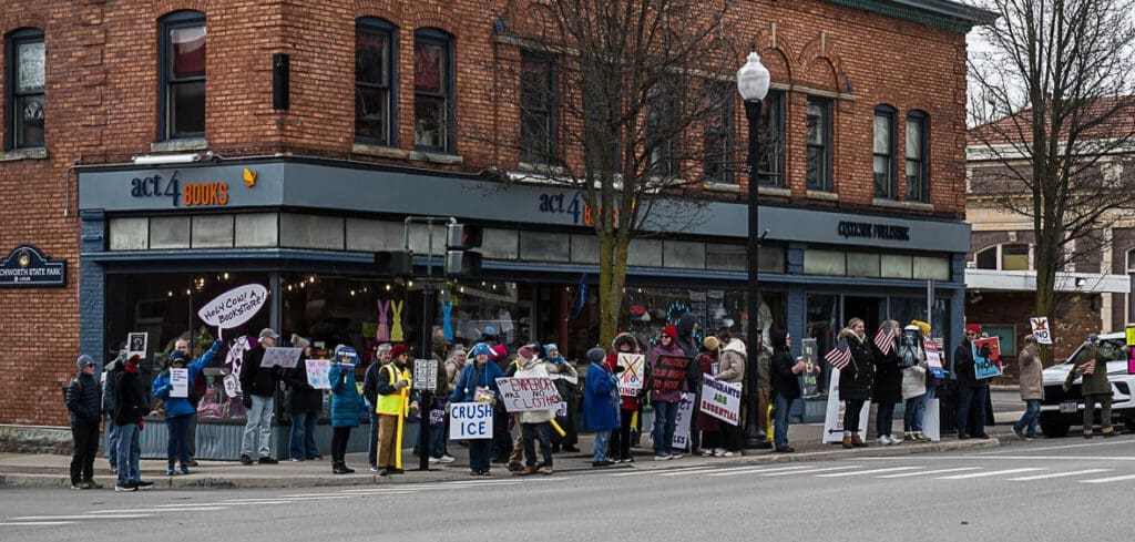 Protesters holding signs outside Act 4 Books bookstore