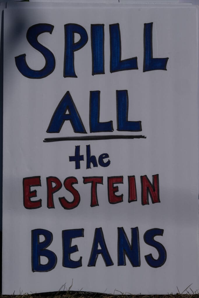 Protest sign reading Spill All the Epstein Beans