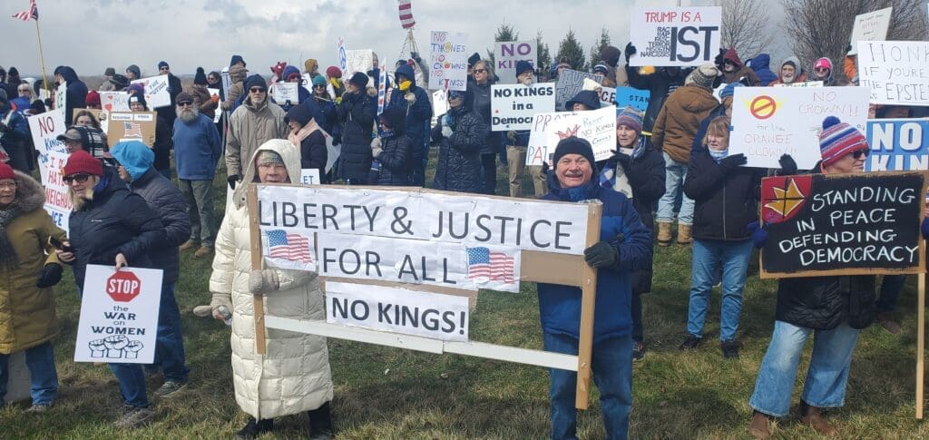 Protesters holding signs supporting democracy and justice