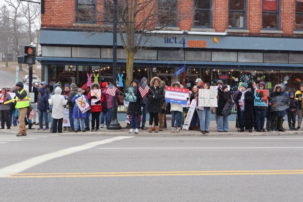 Protesters holding signs and flags outside bookstore