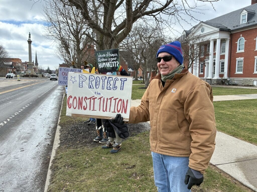 Man holding Protect the Constitution protest sign