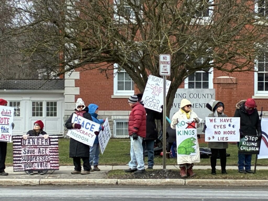 Protesters holding signs outside government building