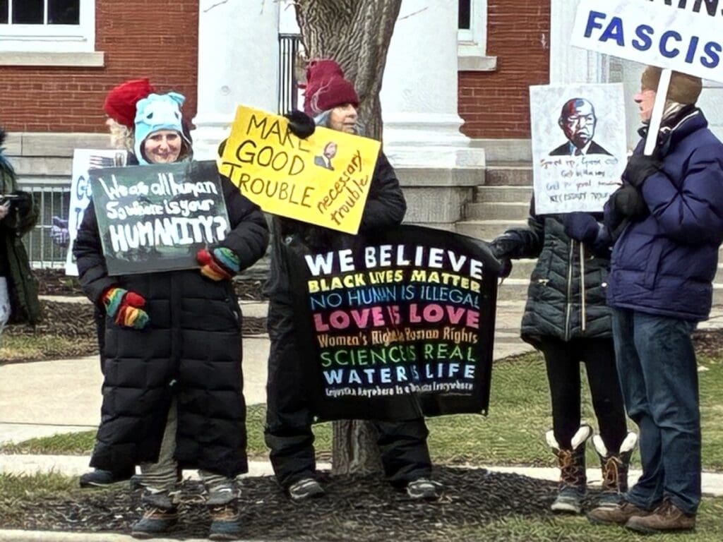 Protesters holding social justice signs outdoors