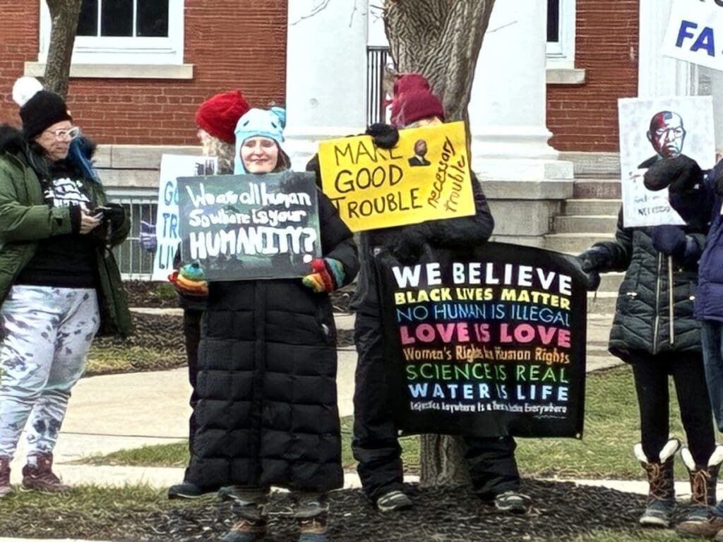 Protesters holding social justice signs outdoors