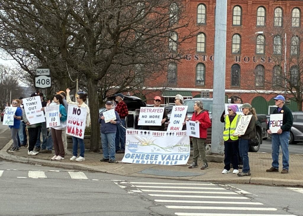 Protesters holding anti-war signs on city sidewalk