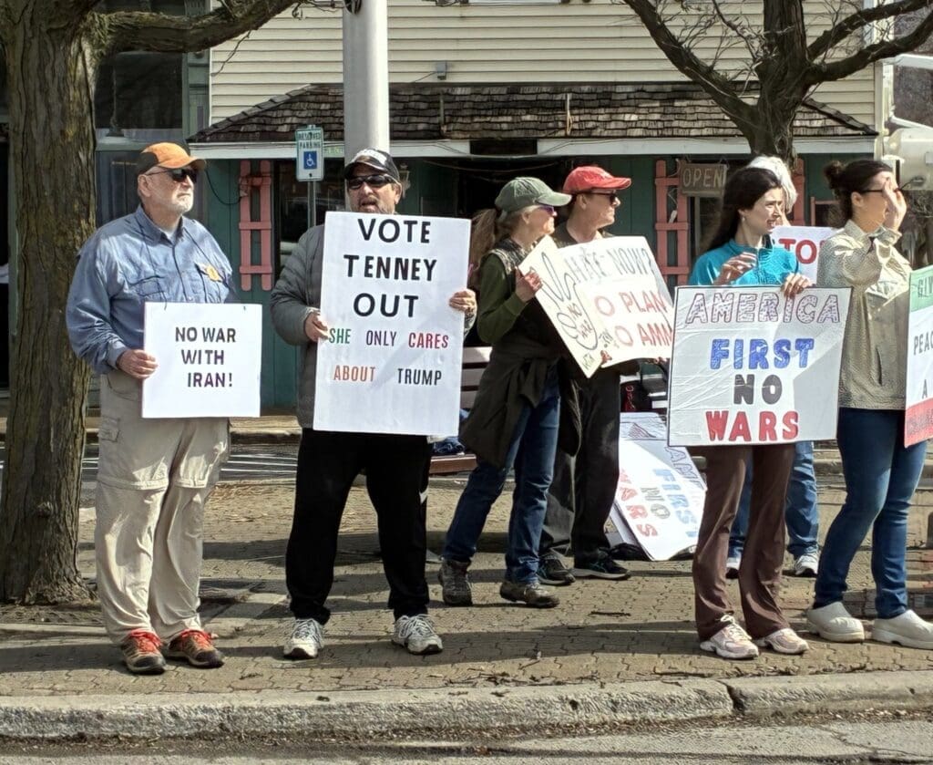 Protesters holding anti-war and political signs