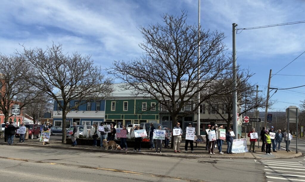 Small-town protest with peace and democracy signs