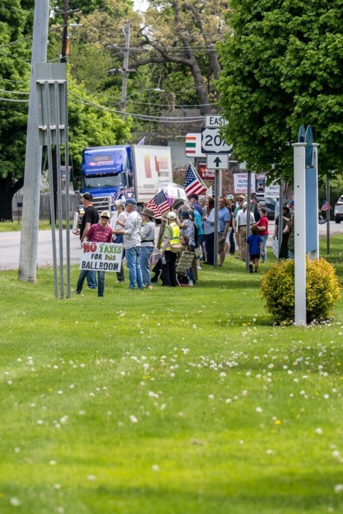 Protesters with American flags holding anti-tax signs